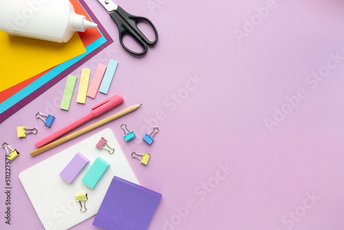 Back to school flat lay. Various office supplies on lilac background, space for text
