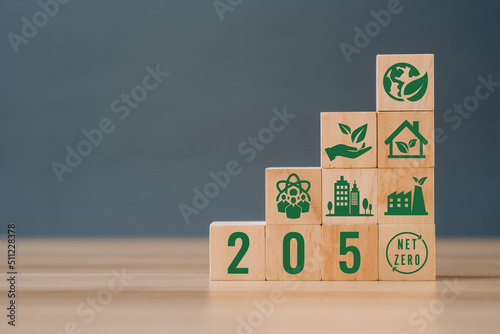 Wooden cubes with net zero icon in 2050 on grey background. Net zero by 2050. Carbon neutral. Net zero greenhouse gas emissions target. Climate neutral long term strategy.