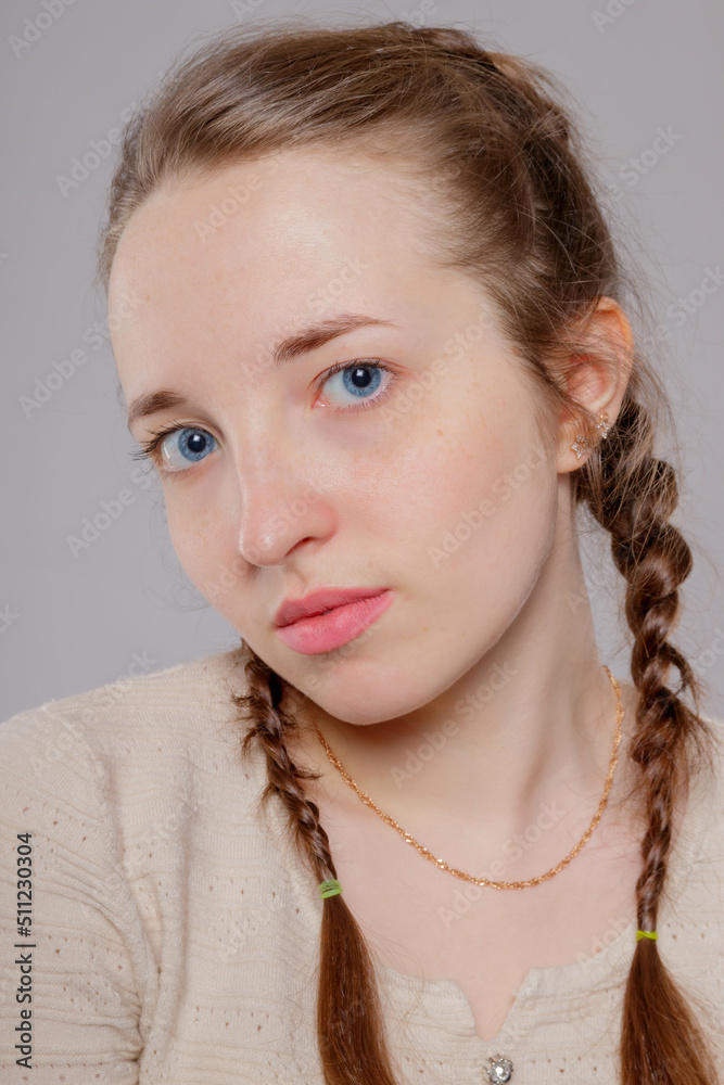 Portrait of a pleasant girl with braids