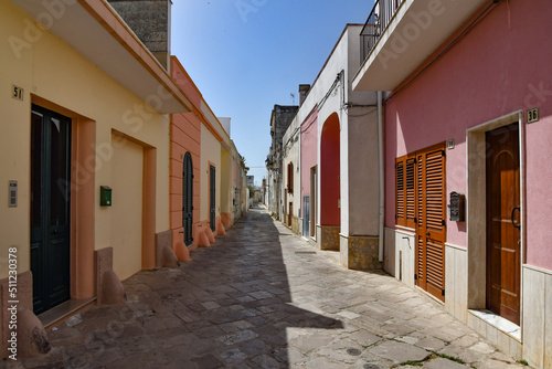 A narrow street between the old houses of Presicce, a picturesque village in the province of Lecce in Italy. photo