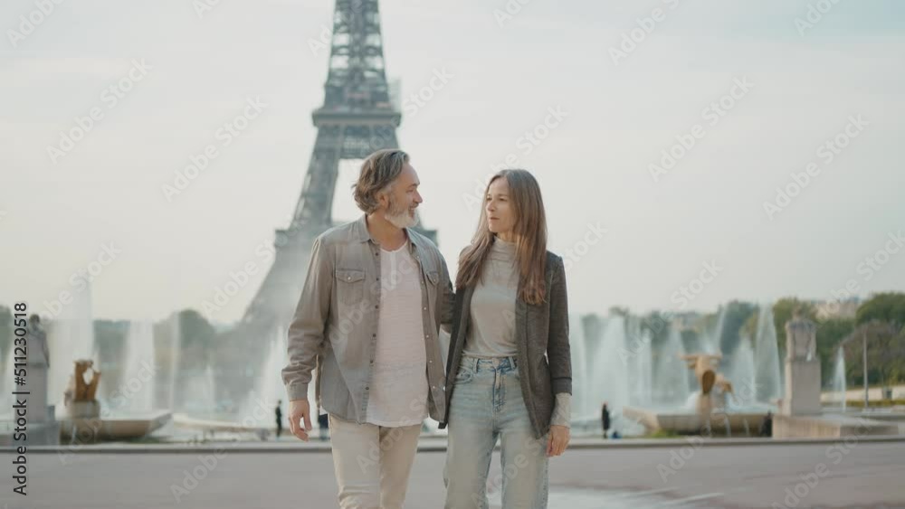 Happy senior couple in Paris. Senior woman and man spending time together at the eiffel tower. Concept about european tourism and landmarks	