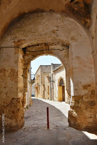 A narrow street between the old houses of Presicce  a picturesque village in the province of Lecce in Italy.
