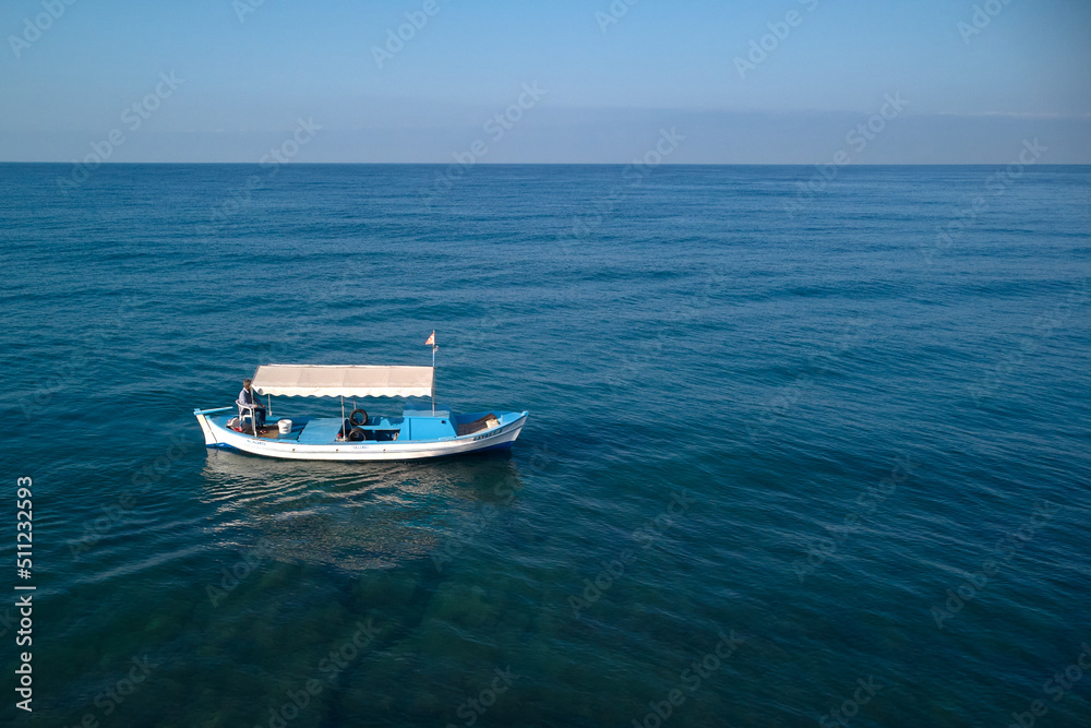 lonely fishing boat in the middle of the sea lonely fishing boat in the middle of the sea