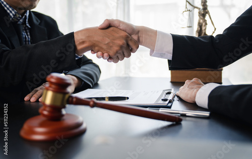 Lawyers shake hands with business people to seal a deal with partner lawyers. or a lawyer discussing contract agreements  handshake concepts  agreements  agreements