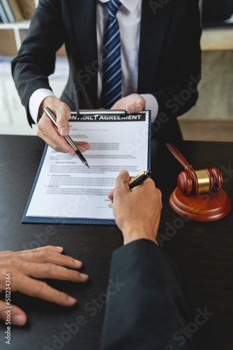 Attorney or judge consulting client's trial at attorney's office, litigation consultation ideas with lawyers.