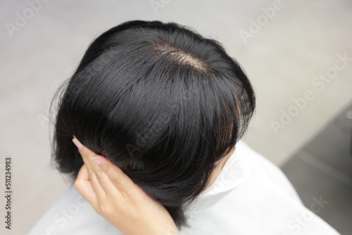 dark-haired woman combing her hair with her fingers