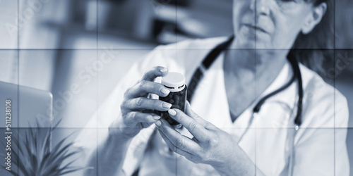 Female doctor looking at a bottle of pills, geometric pattern
