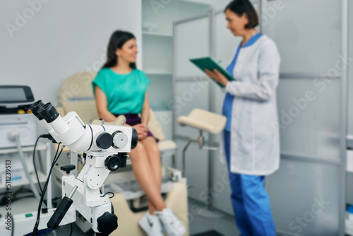 Woman patient sitting in gynecological chair during consultation with her gynecologist in medical clinic. Gynecology