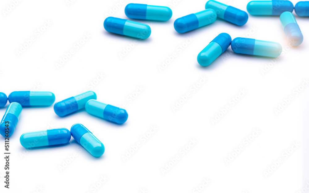 Blue antibiotic capsule pills on white background. Prescription drugs. Antibiotic drug resistance. Antimicrobial capsule pills. Pharmaceutical industry. Healthcare and medicine. Pharmacy product.