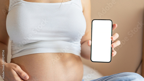 Pregnancy mockup smartphone. Pregnant woman holding smartphone. Mobile pregnancy online maternity application mock up. Concept maternity, pregnancy, childbirth.