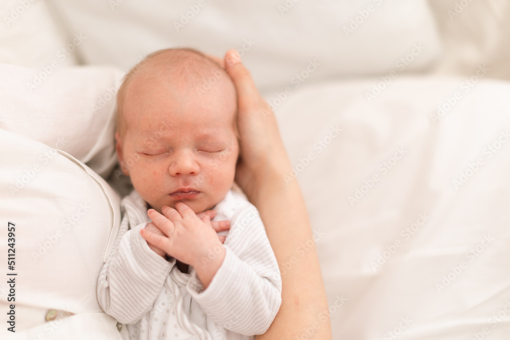 Unrecognizable mother holding her newborn son at home, close-up Unrecognizable mother holding her newborn son at home, close-up