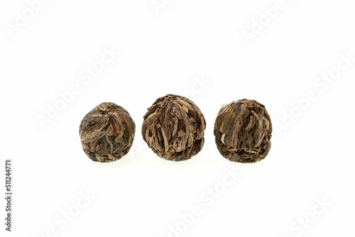 Chinese Green tea with lilies and jasmine on white background. Tea leaves rolled into balls for brewing. Design element for cooking books