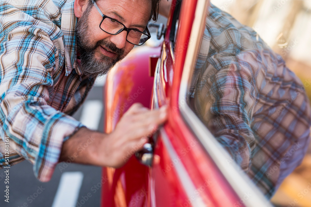 © simona - Close up of man having car of his new car. Vehicle lovers concept with male people checking shiny and polish - owner or mechanic with automobile . Transportation concept and dreaming adult