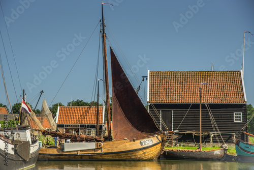 Enkhuizen, Netherlands, June 2022. Old flat-bottomed sailing ships in the harbor of the Zuiderzee Museum in Enkhuizen. photo