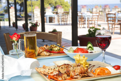 Greek dishes served with drinks on the restaurant table