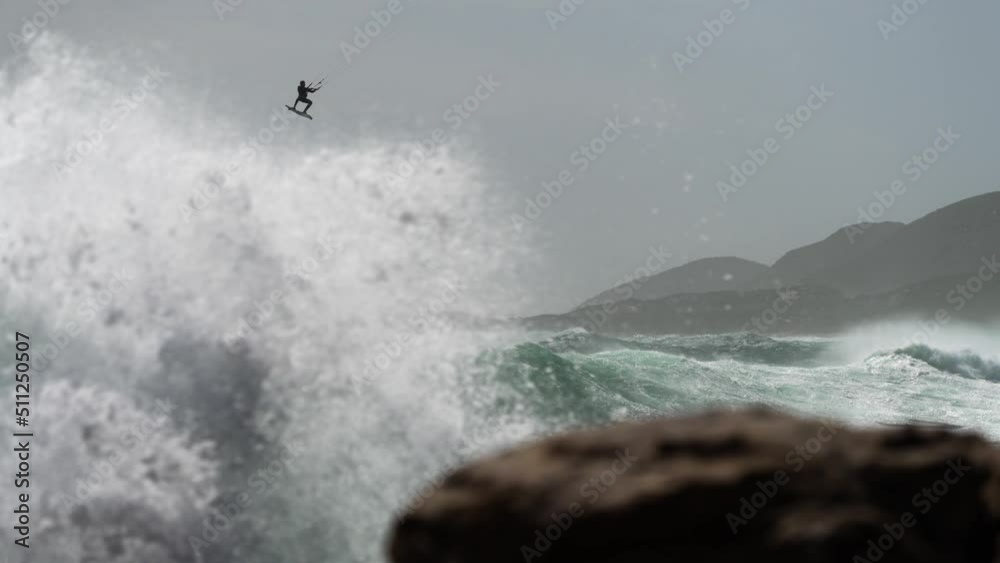 Amazing Extreme Slow Motion Shot of Kitesurfer Performing an Air in Huge Rough Story Waves Amazing Extreme Slow Motion Shot of Kitesurfer Performing an Air in Huge Rough Story Waves
