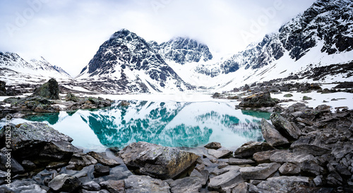 Views of the Lyngen Alps already snowy. Blavatnet - the norwegian glacial Blue Lake in Northern Norway. photo