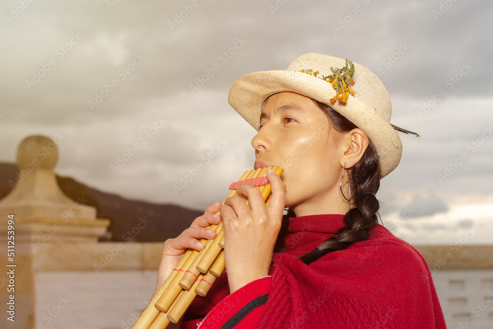 South American indigenous woman in traditional dress playing the