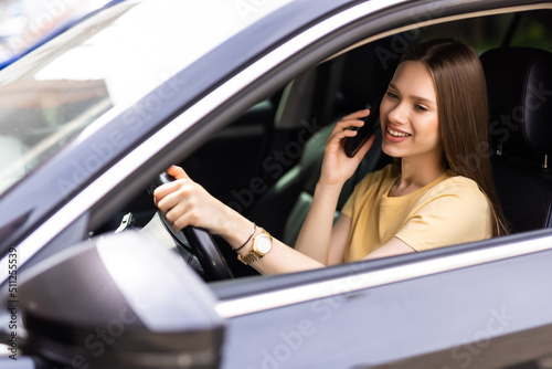 young woman driving car and talking on cell phone concentrating on the road © F8  \ Suport Ukraine