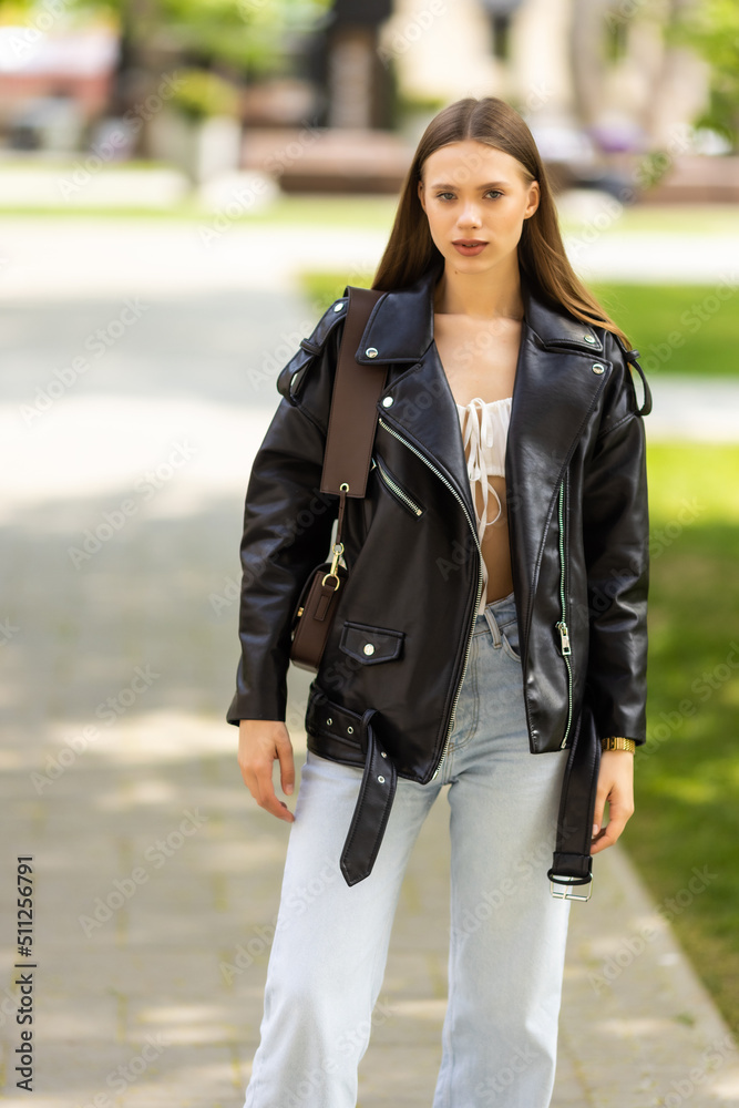 Fototapeta premium Attractive young woman enjoying her time outside in park