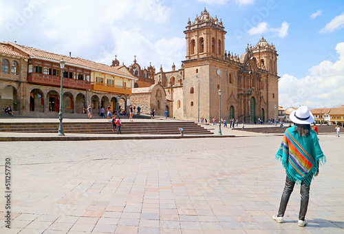 Canvas Print Woman in Peruvian Poncho Looking at Cusco Cathedral, Stunning Landmark of the Hi