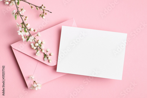 Greeting card mockup with envelope and white flowers on pink background