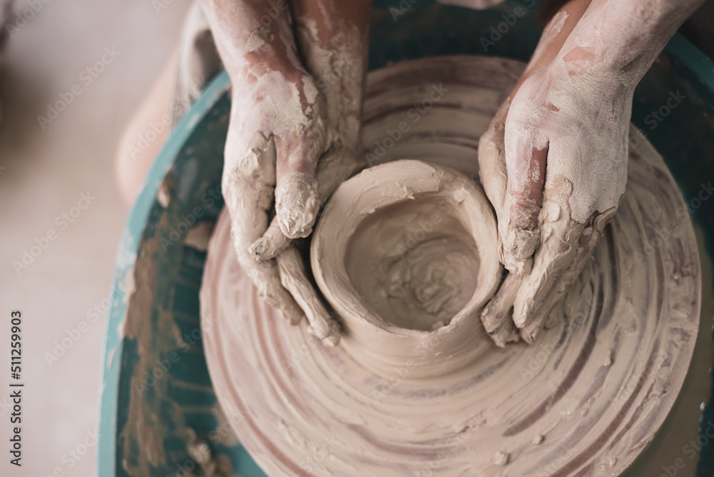 man's Hands careful and lovely hold woman's hands. couple works on potter's wheel. studio on modeling bowl from white clay. Top view. Concept of creative, skill and handmade