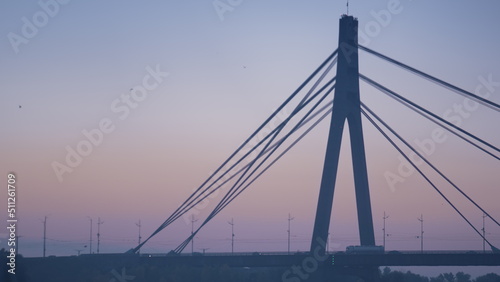 Silhouette bridge tower tranquil evening cityscape. City bridge on sunrise sky © stockbusters