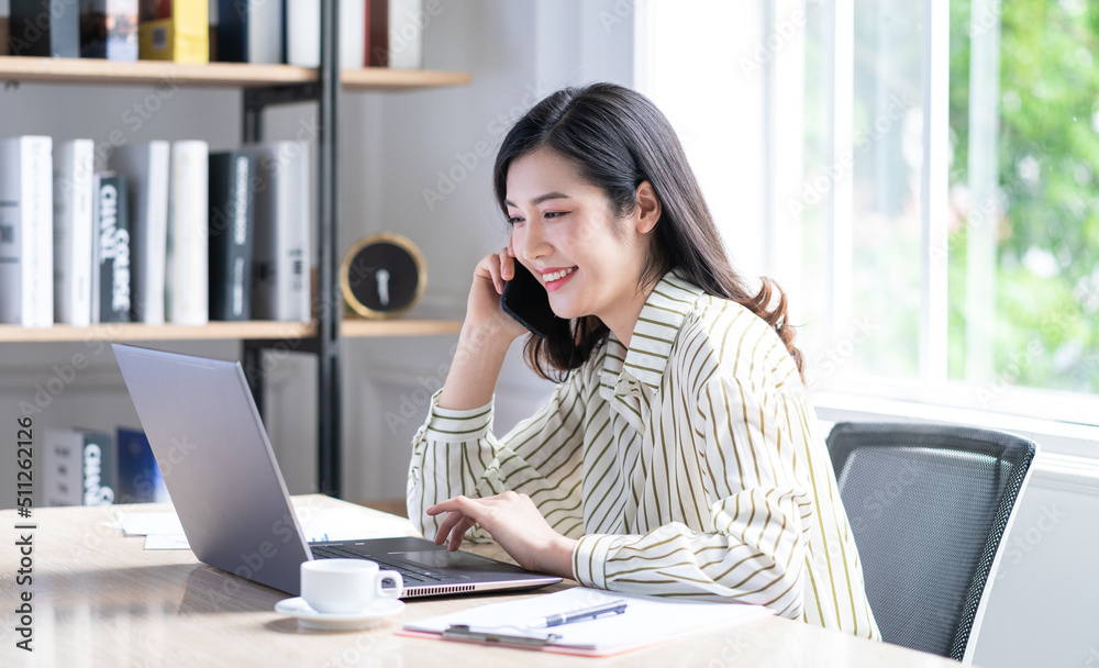 Image of young Asian business woman working at office Image of young Asian business woman working at office
