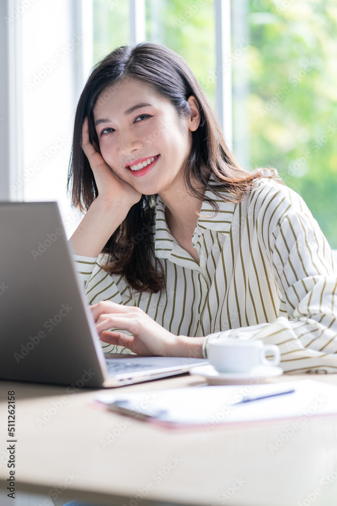 Image of young Asian business woman working at office Image of young Asian business woman working at office
