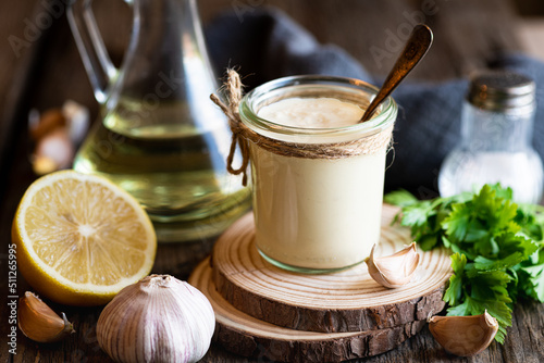 Aioli sauce on a wooden background, selective focus photo