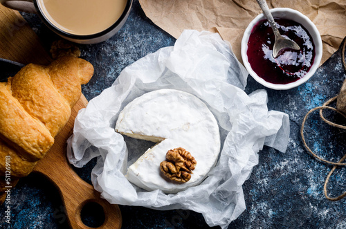 Camembert cheese, brie, grapes, nuts and crackers photo