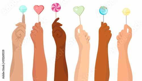 Hands raised up and holding colored lollipops on a stick