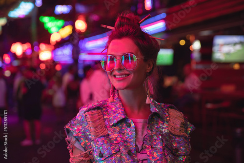 Photography Stylish woman wearing jacket with shining sequins on the city street with neon l