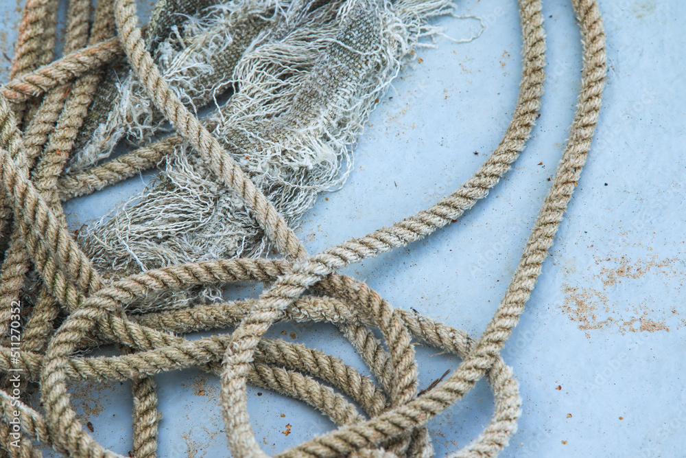 Closeup of coil of nautical rope on fishing boat hull. Closeup of coil of nautical rope on fishing boat hull.
