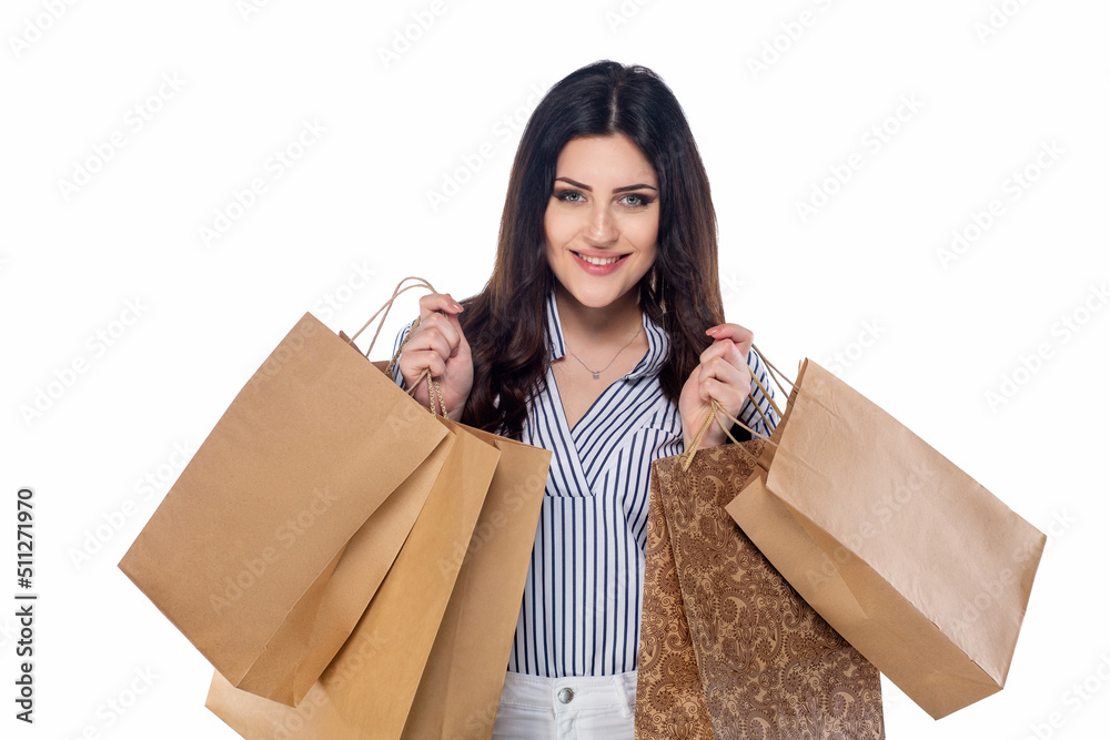 Beautiful brunnet сaucasian young girl in white pants and striped shirt holding shopping bags isolated on white background Beautiful brunnet сaucasian young girl in white pants and striped shirt holding shopping bags isolated on white background