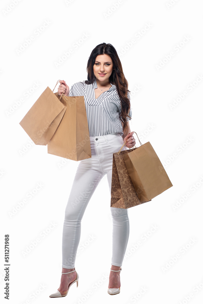 Beautiful brunnet сaucasian young girl in white pants and striped shirt holding shopping bags isolated on white background Beautiful brunnet сaucasian young girl in white pants and striped shirt holding shopping bags isolated on white background