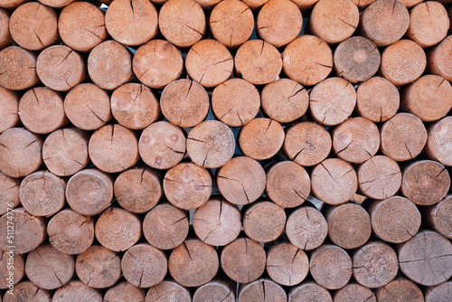 Wooden background. Round bars of wood. A wall of bars