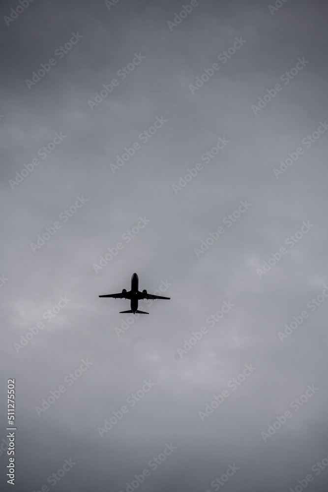 passenger plane flying against the gray sky passenger plane flying against the gray sky