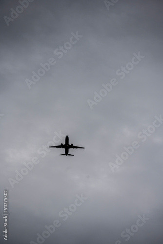 passenger plane flying against the gray sky