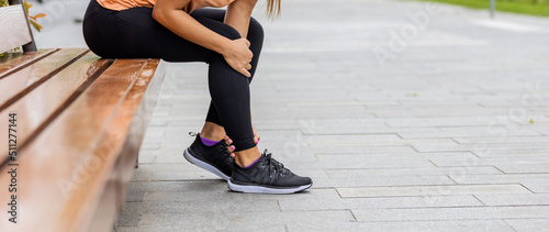 Female athlete with joint or muscle soreness and problem feeling ache in her lower body. Leg Injury. Woman Suffering From Pain In Leg After Workout. Sports Injury. photo