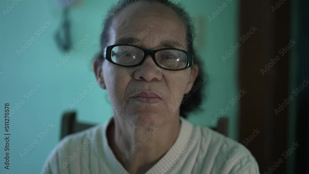 A black Latin woman portrait looking at camera with serious expression A black Latin woman portrait looking at camera with serious expression