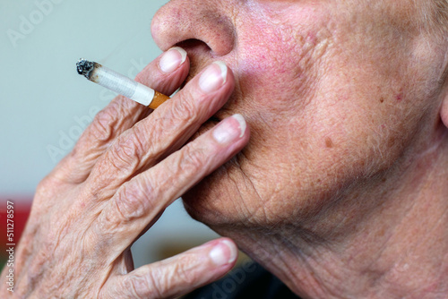 close-up of an old woman smoking a cigarette