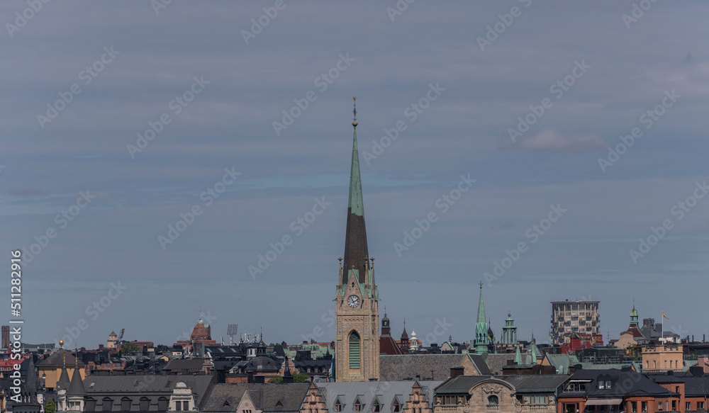 Roofs and the church tower of Oscars Kyrkan in the district Östermalm a sunny summer day in Stockholm