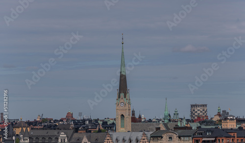 Roofs and the church tower of Oscars Kyrkan in the district Östermalm a sunny summer day in Stockholm