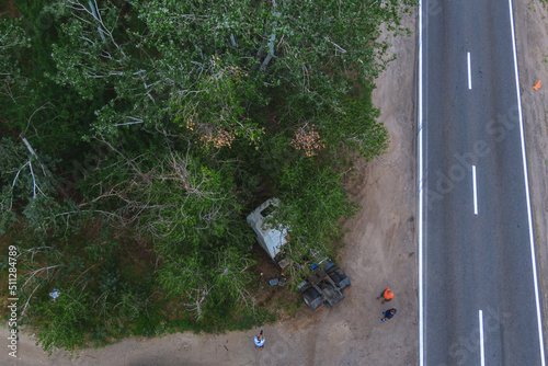 Severe accident. Traffic accidents on the road. View from above. The car got into an accident. Traffic jam. Truck without trailer crashed into a tree