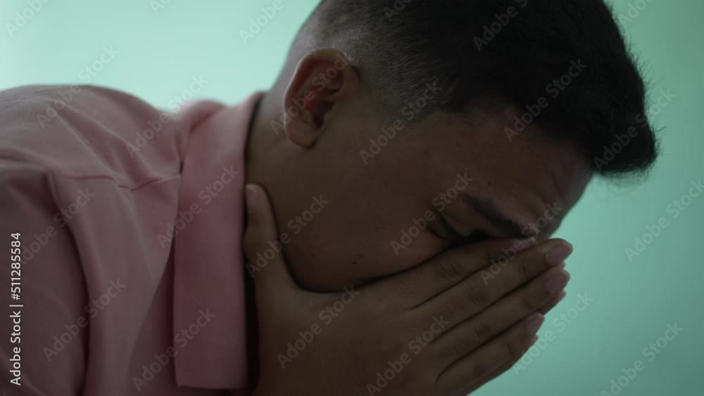 Depressed man in crisis. Sad unhappy person covering face suffering from mental illness Depressed man in crisis. Sad unhappy person covering face suffering from mental illness