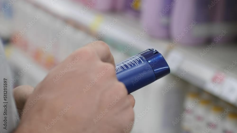 Woman Reading Product Label In Cosmetics Shop Using Mobile Phone Checking Components. Close up. 4K.