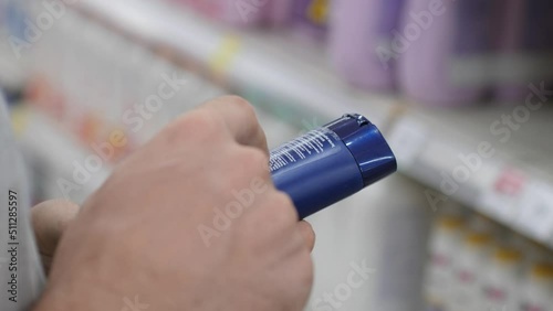 Wallpaper Mural Woman Reading Product Label In Cosmetics Shop Using Mobile Phone Checking Components. Close up. 4K. Torontodigital.ca
