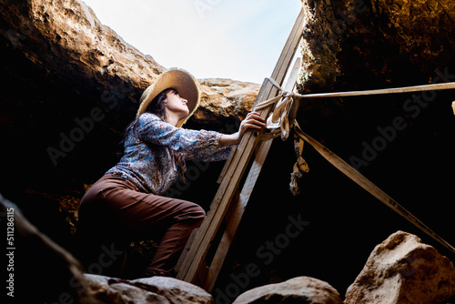 Hiker exploring a cave on vacation